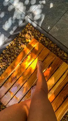 a person laying on the beach with their feet on the floor at Cabaña 25km de Medellín, Benevento Reserva Botánica in Girardota