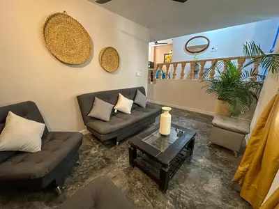 a living room with couches and a coffee table at Villa Athenea-Santorini Colombiano in Puerto Triunfo