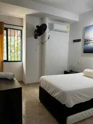 a bedroom with a large bed and a window at Villa Athenea-Santorini Colombiano in Puerto Triunfo