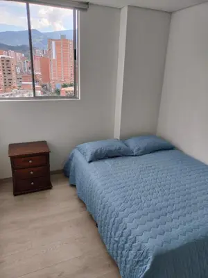 a bedroom with a blue bed and a window at Apartamento Sabaneta Antioquía in Sabaneta