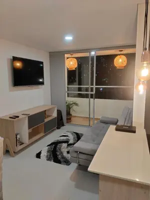 a living room with a couch and a flat screen tv at Apartamento Sabaneta Antioquía in Sabaneta