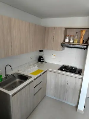 a small kitchen with a sink and a stove at Apartamento Sabaneta Antioquía in Sabaneta