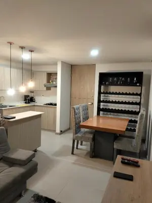 a kitchen and living room with a table and chairs at Apartamento Sabaneta Antioquía in Sabaneta