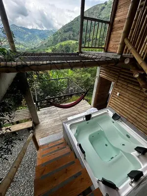 a jacuzzi tub on a deck with a view at Cabaña campestre para parejas o grupos in Manizales