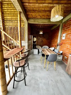 a room with a table and chairs and a brick wall at Cabaña campestre para parejas o grupos in Manizales