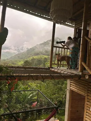 two people taking a picture of a dog on a balcony at Cabaña campestre para parejas o grupos in Manizales