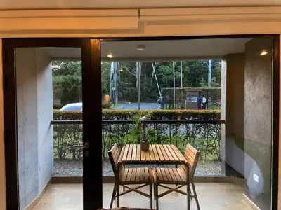 a table and chairs on a patio with a view of a yard at Hotel en Rionegro-Rioverde- Apartamento in Rionegro