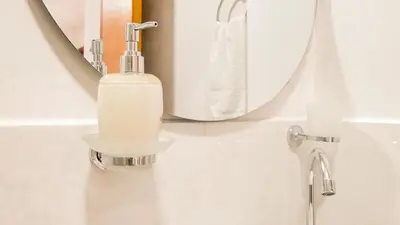 a bathroom with a soap dispenser in front of a mirror at OCASSO JARDIN APARTAMENTO TURPIAL in Jardin