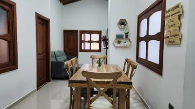 a dining room with a wooden table and chairs at OCASSO JARDIN APARTAMENTO GALLITO DE ROCA in Jardin
