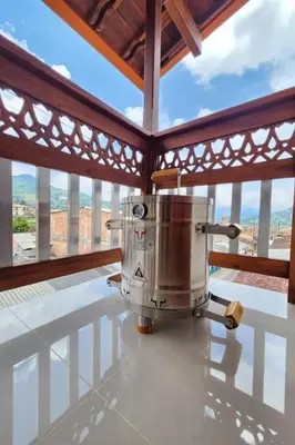 a coffee machine on a table in a room with windows at OCASSO JARDIN APARTAMENTO GALLITO DE ROCA in Jardin