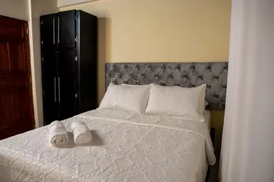 a bedroom with a bed with two towels on it at Finca Villa Isanella, Santuario, Antioquia in Santuario
