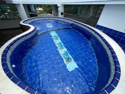 a large blue swimming pool in a house at Penthouse San Rafael in San Rafael