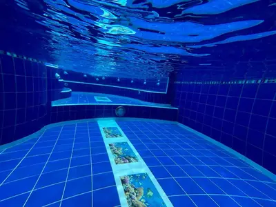 a swimming pool with blue lights in the water at Penthouse San Rafael in San Rafael