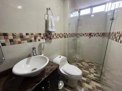 a bathroom with a sink and a toilet and a shower at Penthouse San Rafael in San Rafael