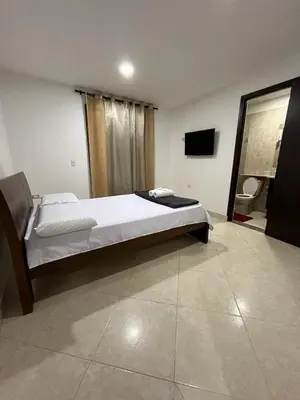 a bedroom with a bed and a television in it at Penthouse San Rafael in San Rafael
