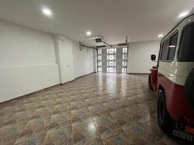 a garage with a red van parked in it at Penthouse San Rafael in San Rafael