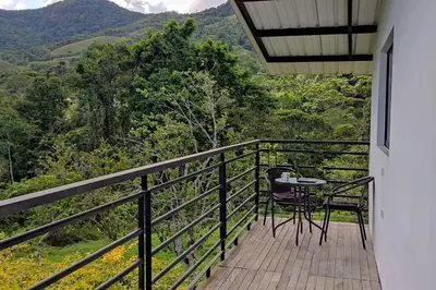 a balcony of a house with a table and chairs at Eco Cabaña San Carlos Ant in San Carlos