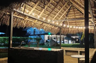 a pavilion with a table and lights in a resort at Eco Cabaña San Carlos Ant in San Carlos