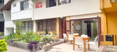 a table and chairs sitting outside of a building at Hostal Saveva Para Grupos Familias Estudiantes y Deportistas in Medellín