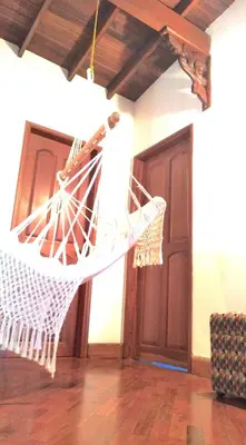 a hammock hanging from a ceiling in a room at Hostal Saveva Para Grupos Familias Estudiantes y Deportistas in Medellín