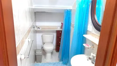 a small bathroom with a toilet and a sink at Hostal Saveva Para Grupos Familias Estudiantes y Deportistas in Medellín