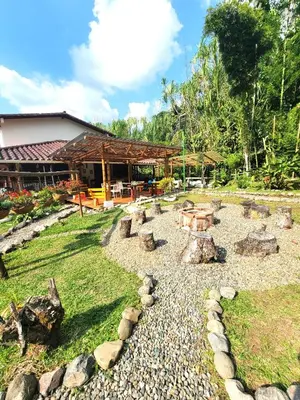a garden with a fire pit in front of a building at PaloSanto, Casa Rural in Jardin