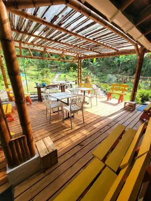 a wooden deck with a table and chairs on it at PaloSanto, Casa Rural in Jardin