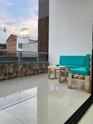 two blue chairs and a table on a balcony at Ubicación Perfecta en Laureles y Confort Total in Medellín
