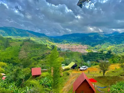 a view of a village with mountains in the background at Cabañas Villa Loe in Jardin