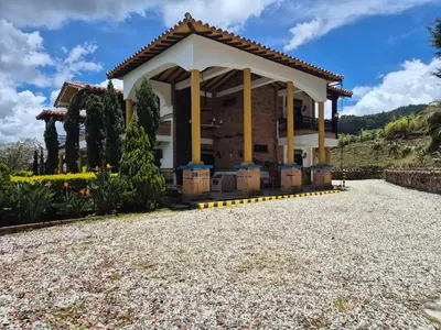 a house with a pavilion on a gravel driveway at AEROPUERTO-Rionegro- MONTEOLIVO COLONIAL in Rionegro