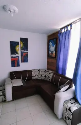 a living room with a brown couch and a window at apartamento centro de la ciudad in Medellín