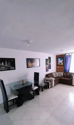 a living room with a table and a couch at apartamento centro de la ciudad in Medellín