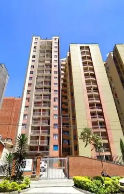 two tall buildings with palm trees in front of them at apartamento centro de la ciudad in Medellín