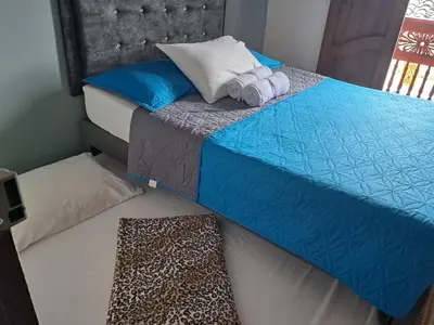 a bedroom with a bed with towels on it at HOSTAL LA CASA DE LOS SUEÑOS in Jardin
