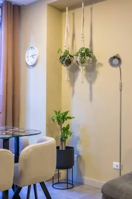 a dining room with a table and a clock on the wall at Apartamento Tranvía 210 in Medellín