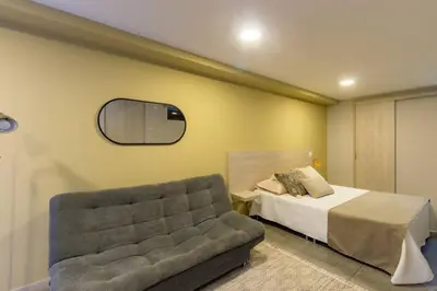 a bedroom with a bed and a couch at Apartamento Tranvía 210 in Medellín