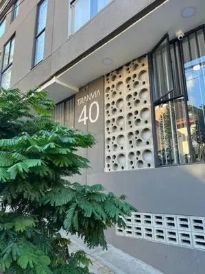 a building with a sign on the side of it at Apartamento Tranvía 210 in Medellín