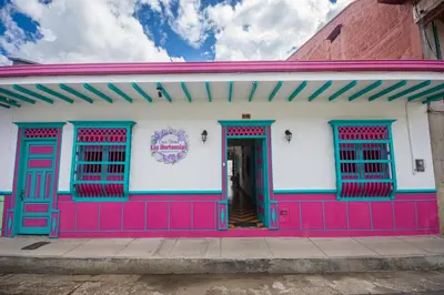 a colorful building with red and blue doors and windows at CASA HOTEL LAS HORTENSIAS in Jardin