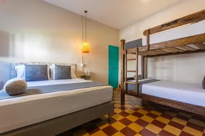 a bedroom with two bunk beds and a checkered floor at CASA HOTEL LAS HORTENSIAS in Jardin