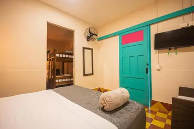 a room with a bed and a green door at CASA HOTEL LAS HORTENSIAS in Jardin
