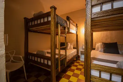 two bunk beds in a room with a checkered floor at CASA HOTEL LAS HORTENSIAS in Jardin