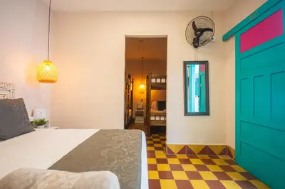 a bedroom with a bed and a checkered floor at CASA HOTEL LAS HORTENSIAS in Jardin