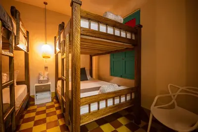 a room with two bunk beds and a lamp at CASA HOTEL LAS HORTENSIAS in Jardin