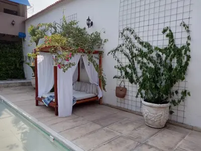 a porch with a gazebo with plants on it at casa lumka hotel boutique spa in Mariquita