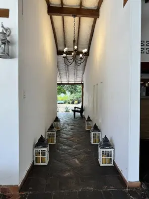 a hallway with a chandelier and some lights at casa lumka hotel boutique spa in Mariquita