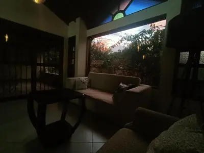 a living room with a couch and a large window at Casa Campestre 1 Nivel para 9H , Poblado San Lucas 110 in Medellín