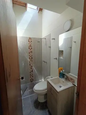 a bathroom with a toilet and a sink and a shower at Casa Campestre 1 Nivel para 9H , Poblado San Lucas 110 in Medellín