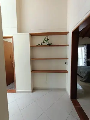a living room with white walls and shelves at Casa Campestre 1 Nivel para 9H , Poblado San Lucas 110 in Medellín