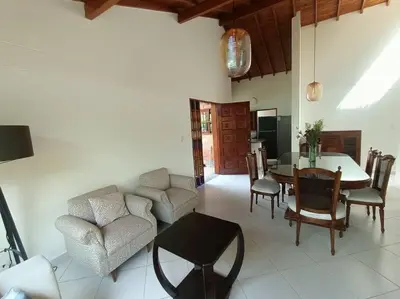a living room with a dining room table and chairs at Casa Campestre 1 Nivel para 9H , Poblado San Lucas 110 in Medellín