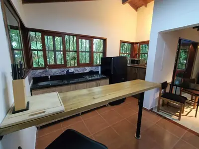 a kitchen with a wooden counter top and windows at Loft campestre con terraza en el Poblado apt 113 in Medellín